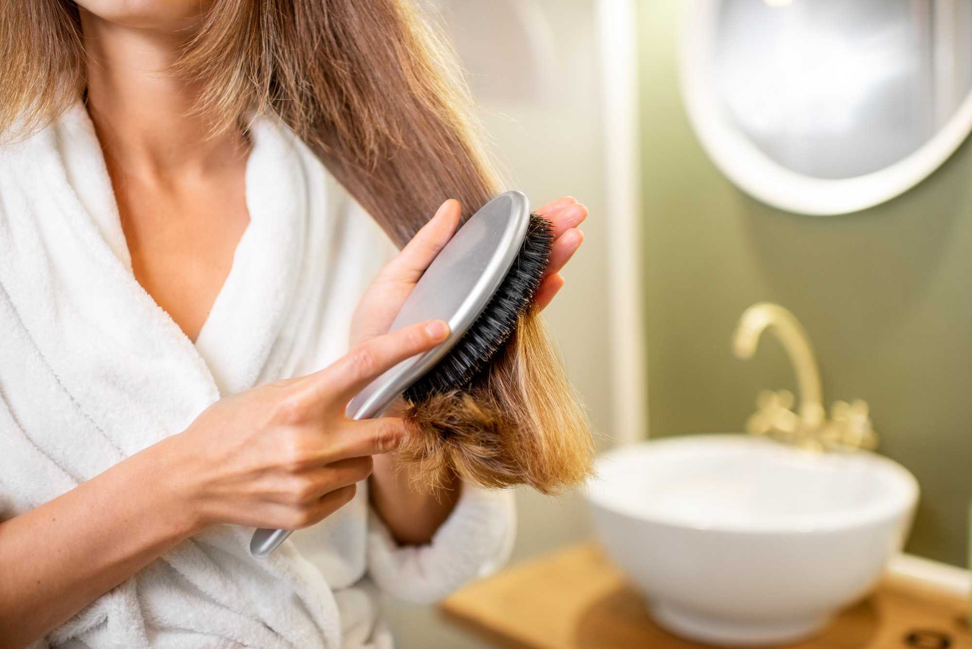 Combing hair in the bathroom